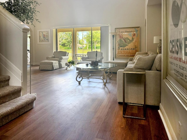 1915 SW Panther Trce, Stuart, FL 34997 - living room featuring a towering ceiling, wood finished floors, arched walkways, and stairs
