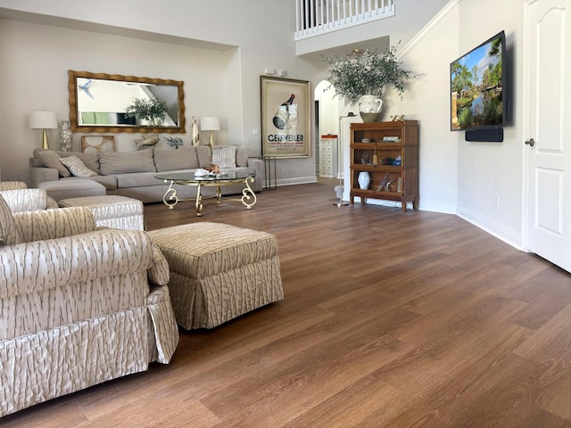 1915 SW Panther Trce, Stuart, FL 34997 - living room featuring a towering ceiling, wood finished floors, and baseboards