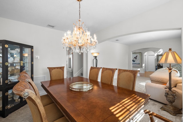 1915 SW Panther Trce, Stuart, FL 34997 - dining room with a chandelier, visible vents, and arched walkways
