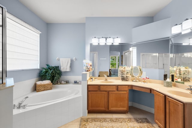 bathroom with plus walk in shower, vanity, and tile patterned flooring