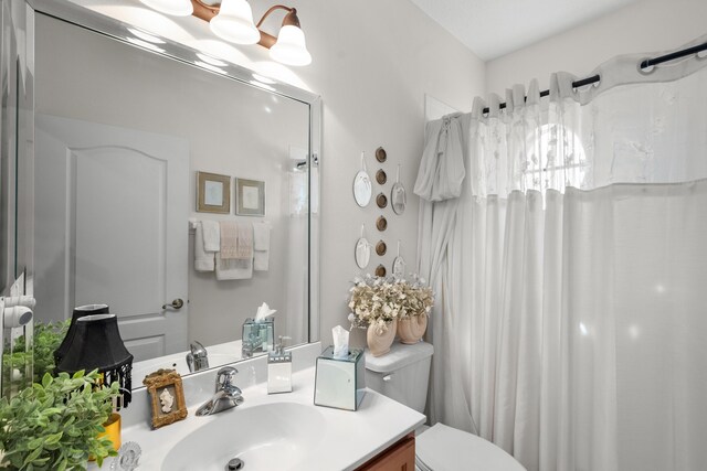 1915 SW Panther Trce, Stuart, FL 34997 - bathroom with toilet, vanity, and a shower with shower curtain