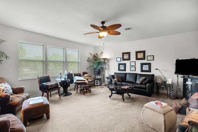 living room featuring carpet flooring and ceiling fan