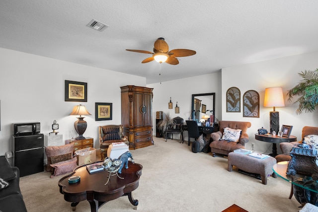 1915 SW Panther Trce, Stuart, FL 34997 - carpeted living room featuring a textured ceiling, visible vents, and a ceiling fan