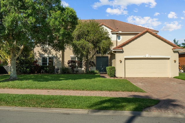 mediterranean / spanish-style home featuring a garage and a front lawn