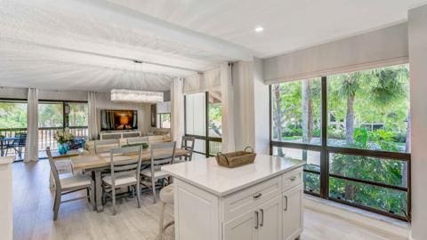 kitchen with white cabinetry, a center island, and light wood-type flooring