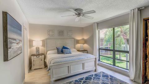 bedroom with a textured ceiling and ceiling fan