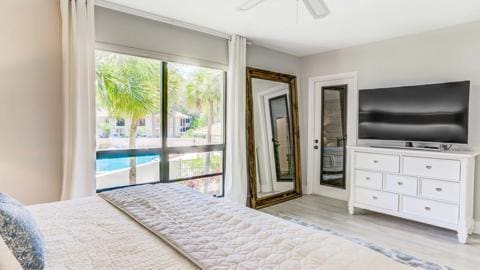 bedroom with light wood-type flooring, access to exterior, and ceiling fan