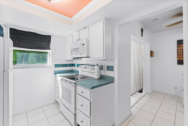 kitchen featuring backsplash, white cabinetry, light tile patterned floors, white appliances, and ornamental molding