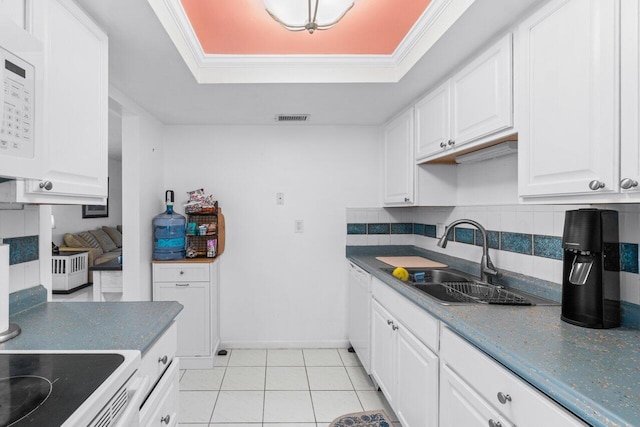 kitchen with decorative backsplash, sink, white cabinetry, and crown molding