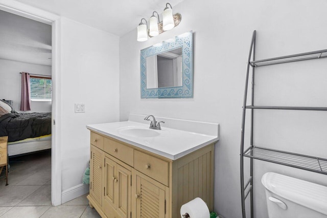 bathroom featuring toilet, tile patterned floors, and vanity