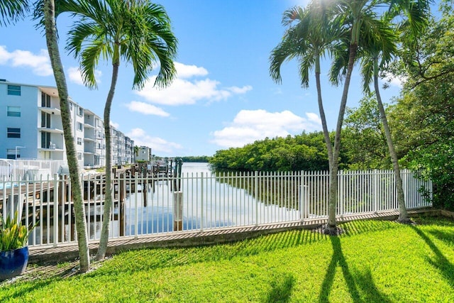 exterior space with a water view, a yard, and a boat dock