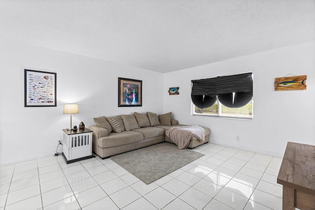 living room featuring a textured ceiling and light tile patterned floors