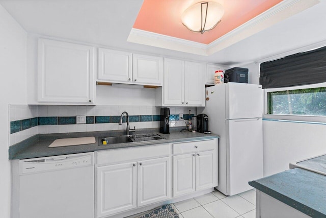 kitchen featuring sink, white appliances, white cabinetry, and a raised ceiling