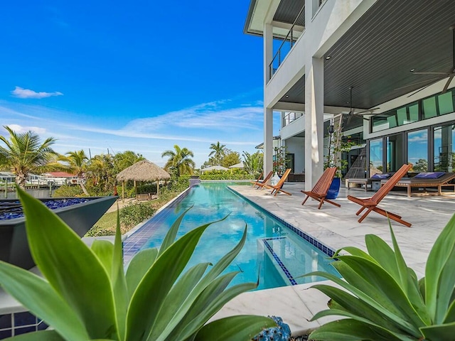 view of pool with a gazebo, ceiling fan, and a patio