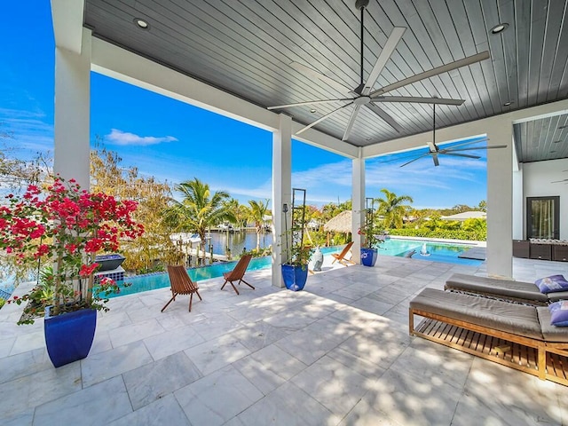 view of patio / terrace with a water view and ceiling fan