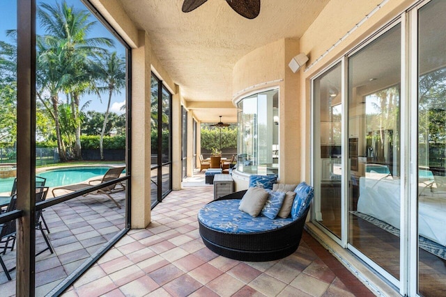 sunroom featuring ceiling fan