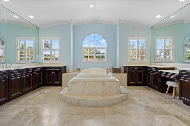 bathroom featuring vanity, ornamental molding, tiled bath, and lofted ceiling