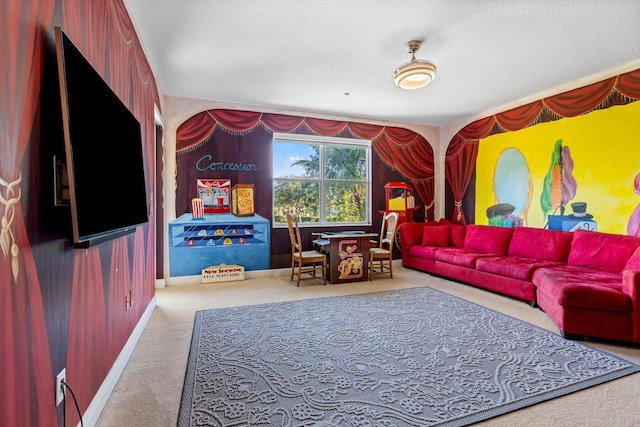 recreation room with a textured ceiling and carpet floors