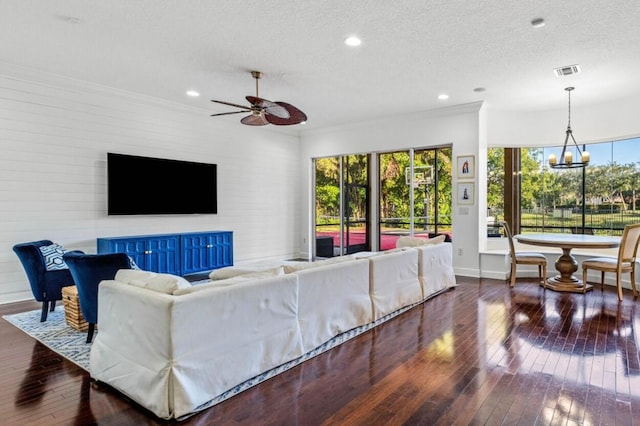 living room with plenty of natural light, a textured ceiling, and dark hardwood / wood-style floors