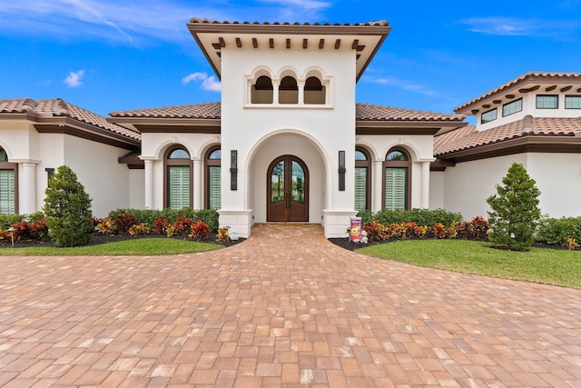 mediterranean / spanish-style house featuring french doors