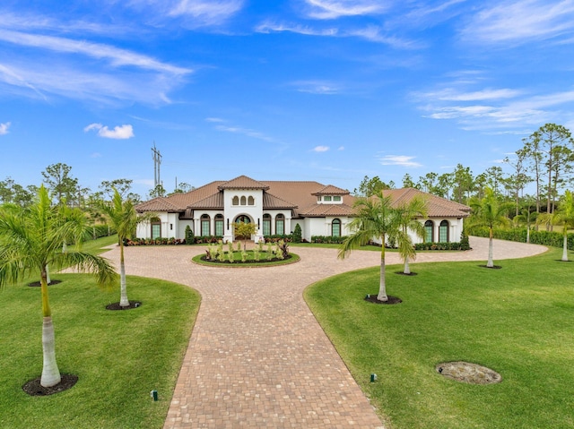 mediterranean / spanish home with a front yard