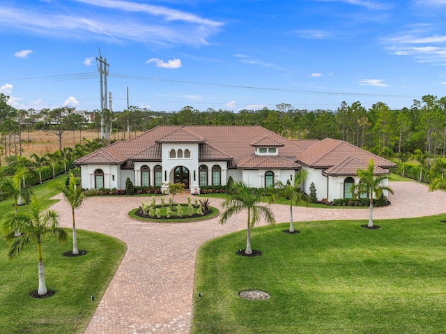 mediterranean / spanish-style home featuring a front lawn