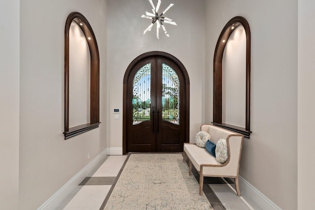 entryway featuring french doors and an inviting chandelier