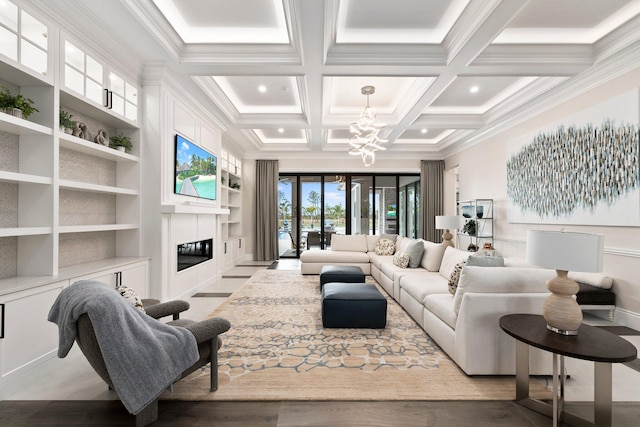 living room with an inviting chandelier, beam ceiling, coffered ceiling, a tiled fireplace, and built in shelves