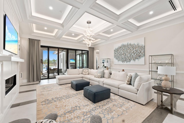 living room featuring beamed ceiling, ornamental molding, and an inviting chandelier