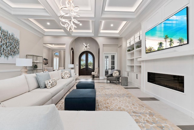 living room with french doors, coffered ceiling, an inviting chandelier, built in features, and beam ceiling