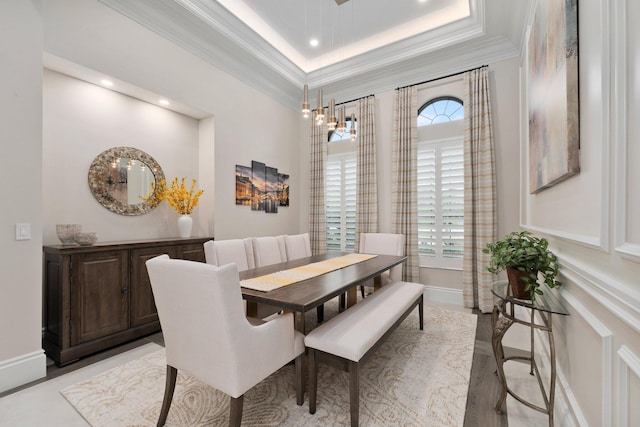 dining room with crown molding and a raised ceiling