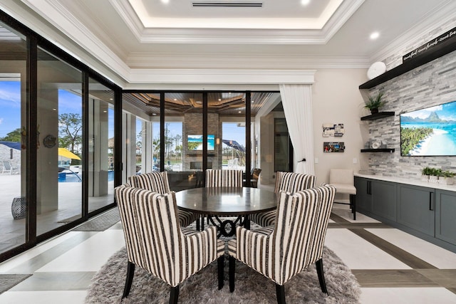 dining space featuring crown molding and a tray ceiling