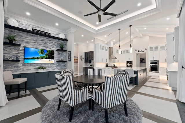 dining space featuring ceiling fan, beam ceiling, and high vaulted ceiling