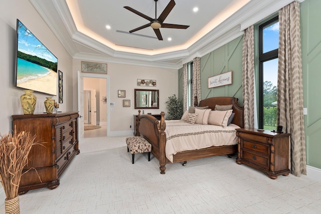 bedroom with ceiling fan, ornamental molding, and a raised ceiling