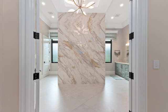 hallway featuring a notable chandelier and crown molding