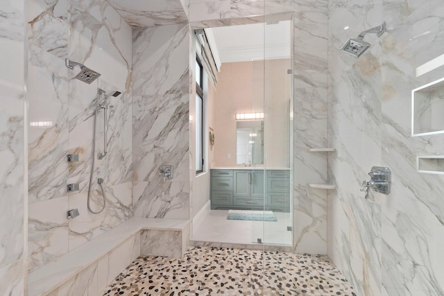 bathroom featuring a tile shower and vanity