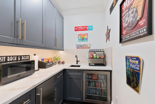 bar with gray cabinets, sink, wine cooler, and light stone counters