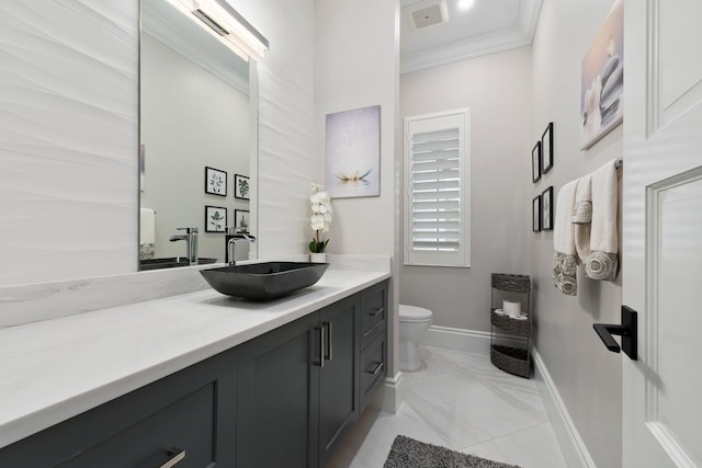 bathroom featuring ornamental molding, vanity, and toilet