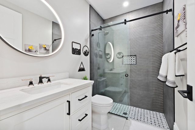 bathroom featuring walk in shower, vanity, toilet, and tile patterned flooring