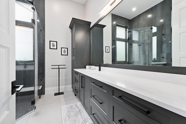 bathroom featuring tile patterned flooring, vanity, and a shower with shower door