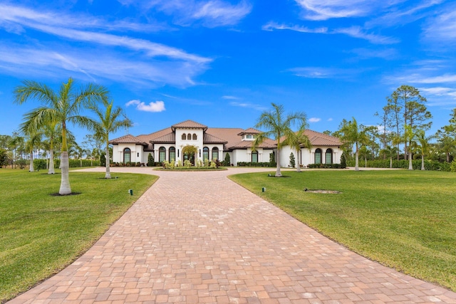 mediterranean / spanish-style home with a front yard