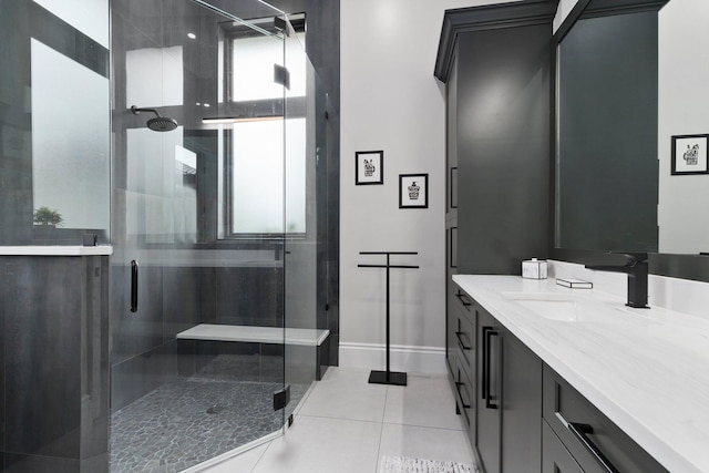 bathroom featuring tile patterned flooring, vanity, and a shower with shower door