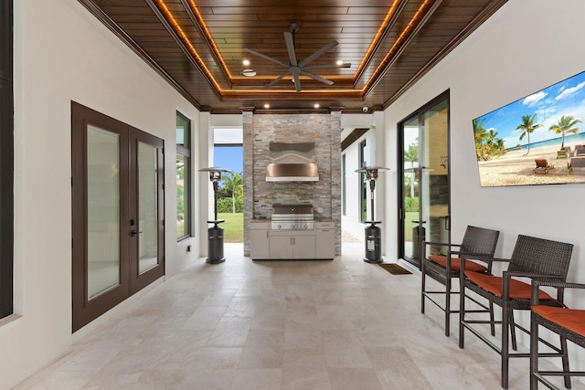 sunroom / solarium with wood ceiling and french doors