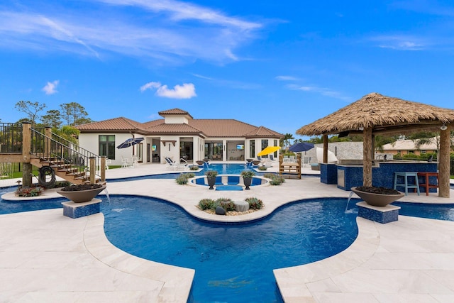 view of pool with a bar, a gazebo, and a patio area