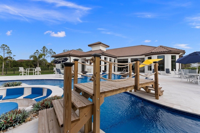 view of swimming pool with a patio