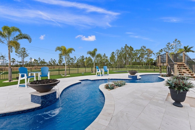 view of swimming pool featuring a lawn and a patio area