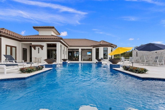 view of pool with a patio area and ceiling fan