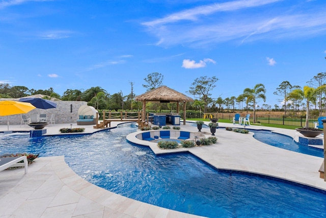 view of swimming pool featuring a gazebo, pool water feature, an in ground hot tub, and a patio area