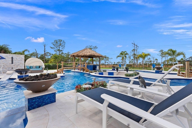 view of pool with a gazebo, pool water feature, and a patio area