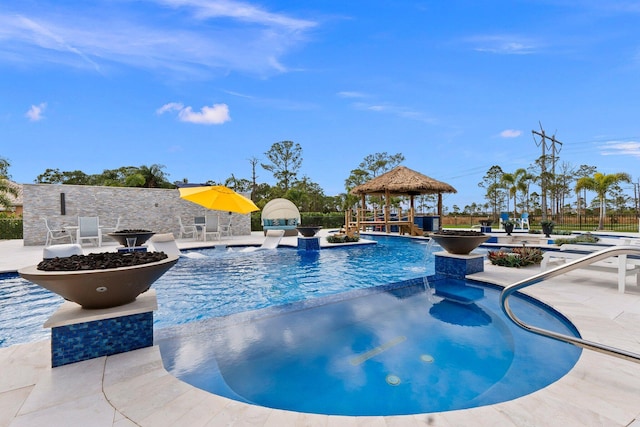 view of swimming pool featuring a gazebo, pool water feature, and a patio